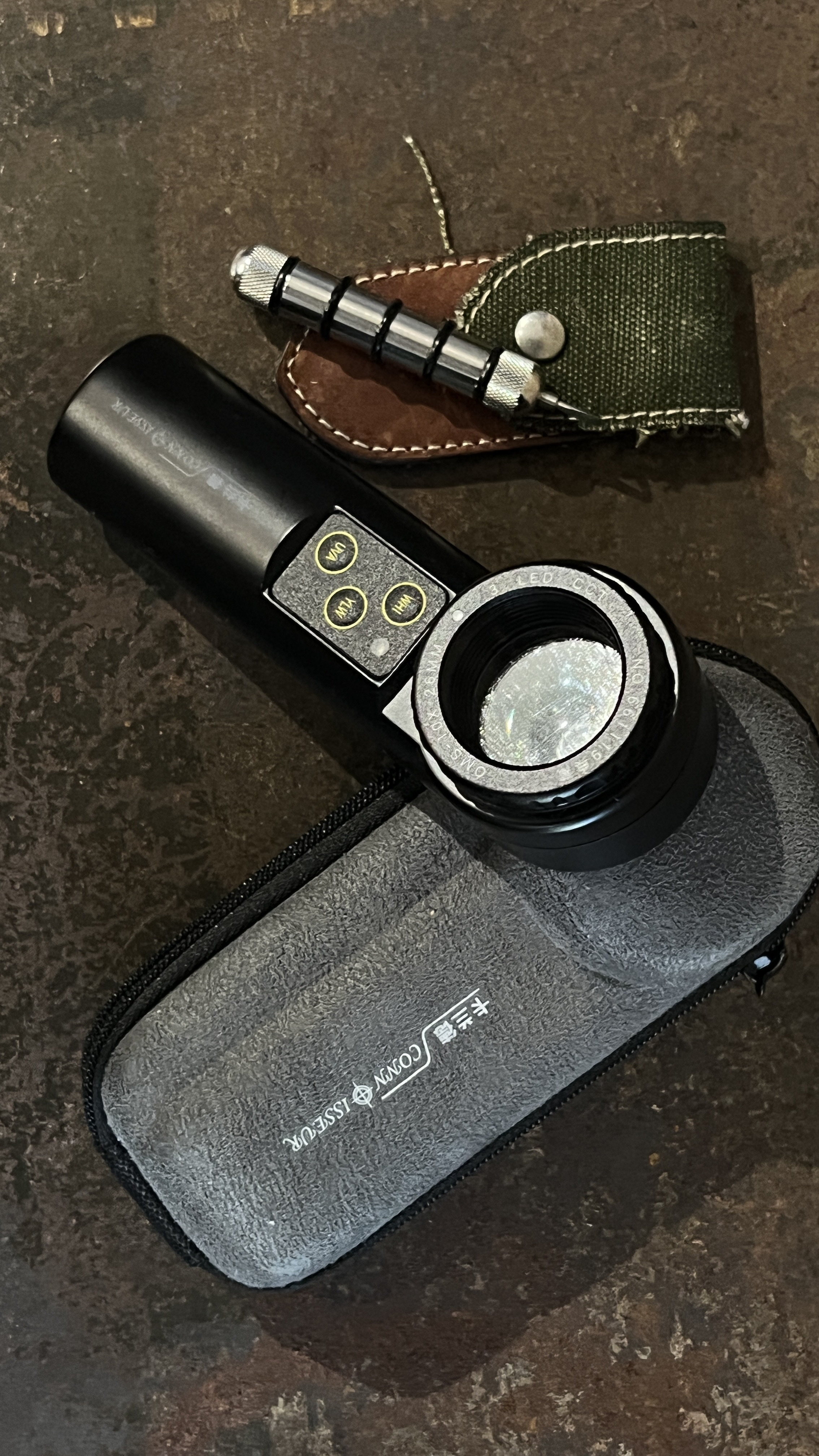 Watchmaker inspecting a timepiece with a loupe